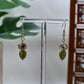 Gold Medallion Dangle Earrings with Green Leaf Charm