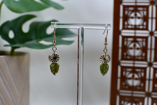 Gold Medallion Dangle Earrings with Green Leaf Charm