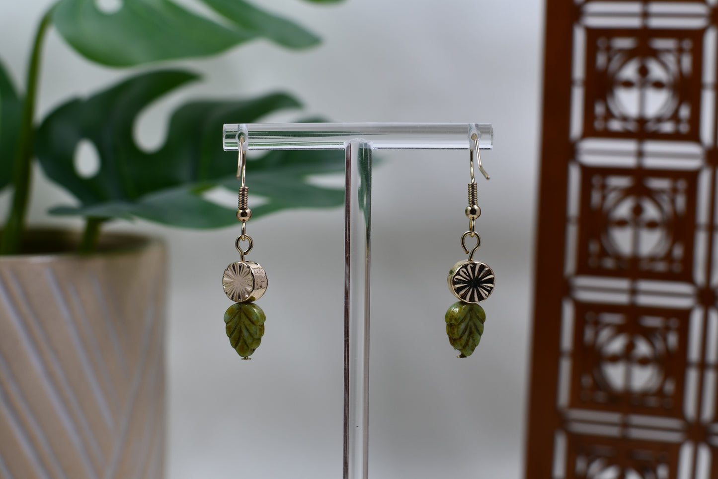 Gold Medallion Dangle Earrings with Green Leaf Charm